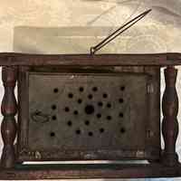          Side view of foot warmer with door opening in front.
   