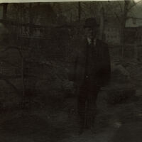 Marshall-Schmidt Album: Man Standing Outside, Factory Chimney in Background