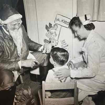 Dunn: Photograph of Bob Dunn visiting a Children's Hospital at Christmastime