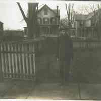 Marshall-Schmidt Album: Boy Standing on Sidewalk with Houses Behind