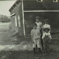 Marshall-Schmidt Album: Boys Standing Outside a Barn