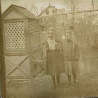 Marshall-Schmidt Album: Two Girls Standing Near Path, House Behind