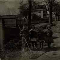 Marshall-Schmidt Album: Children Holding a Rake and Vegetables on a Dirt Road