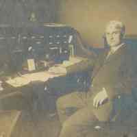 Snow: Unknown Male Seated at Desk