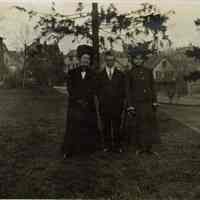 Marshall-Schmidt Album: Two Girls and Young Man Standing Outside