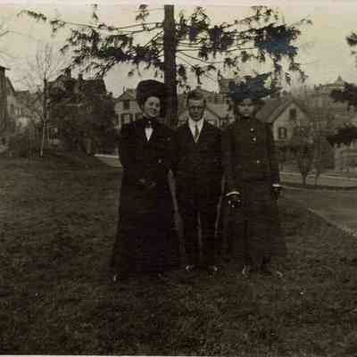 Marshall-Schmidt Album: Two Girls and Young Man Standing Outside