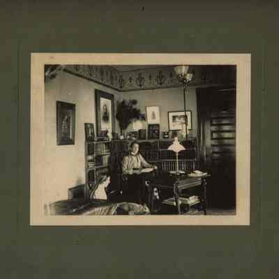 Snow: Woman with Open Book Seated at a Desk
