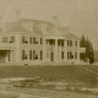          Oliver Chamberlain edits to photo: corrected about 2 degrees to vertical, cropped some of the foreground, but left the indication of a driveway, and darkened it a bit, making the trees without leaves in the right foreground a bit better defined, as are the dormers.
   