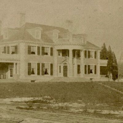Oliver Chamberlain edits to photo: corrected about 2 degrees to vertical, cropped some of the foreground, but left the indication of a driveway, and darkened it a bit, making the trees without leaves in the right foreground a bit better defined, as are the dormers.