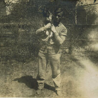 Marshall-Schmidt Photo Album: Boy Holding a Dog on his Shoulders