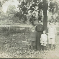 Marshall-Schmidt Album: Family Standing Under a Tree