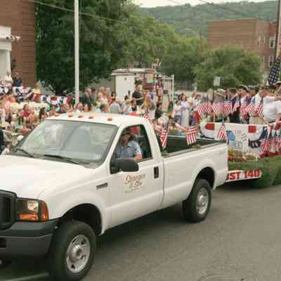 Front of the float white shirt. Former Millburn Township Schools Superintendent Dr. Paul Rossey. Legionnaire on right is Norman Mayo.