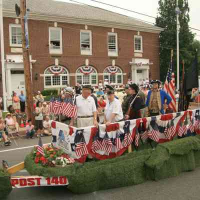 Front of the float white shirt. Former Millburn Township Schools Superintendent Dr. Paul Rossey, Legionnaire on right is Norman Mayo.