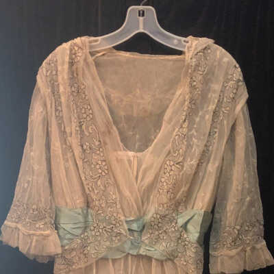 Dress: Layered White Woman's Dress with Light Blue Sash and Black Floral Embroidery