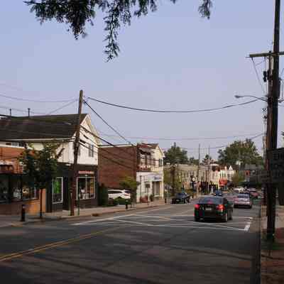 Main Street Millburn looking south: Town yard (11 Main Street) and Common Lot Restaurant on the right. Former Suburban Paints, Frames and Framers on the left.