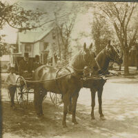 Marshall-Schmidt Album: Two Men Seated in Horse Drawn Wagon, House in Background