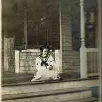 Marshall-Schmidt Album: Young Girl Seated on Porch