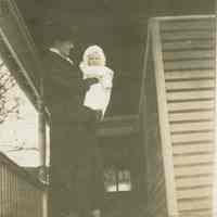 Marshall-Schmidt Album: Woman on Porch Holding a Baby