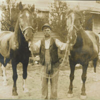 Marshall-Schmidt Album: Man with Two Horses Outside a House