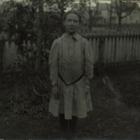 Marshall-Schmidt Album: Margaret Marshall Standing with Fence Behind