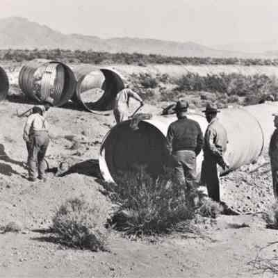 Union Pacific Railroad - track workers laying steel culvert pipe