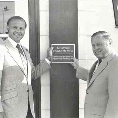 Boulder Dam Hotel 1980 historic building plaque holding the plaque are Cliff McCorkle, owner, and Robert Sears, Boulder City Fire Chief