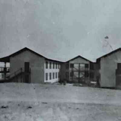 Boulder City Six dormitory "A Six Co.'s bunkhouse, with Six Co.'s commissary in background"