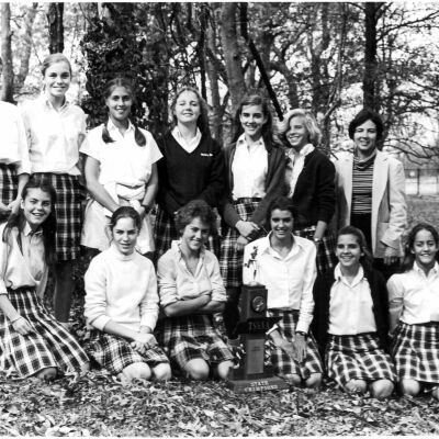 Harpeth Hall students and coach pose with 1981 TSSAA Trophy