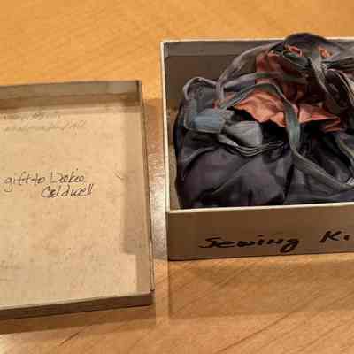 Box lid and inside view of box containing sewing kit, gift to Dakie Caldwell