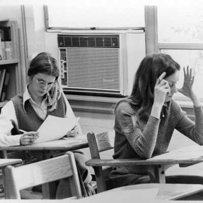 Two girls, Leslie Jones and Janie Dowden studying in the classroom by the window.