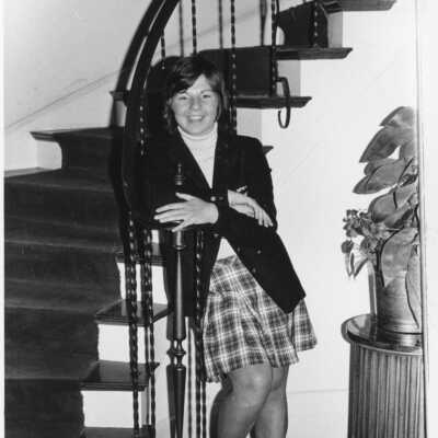 AFS student from Belgium, 1973. Student standing cross-armed at the bottom of the steps.