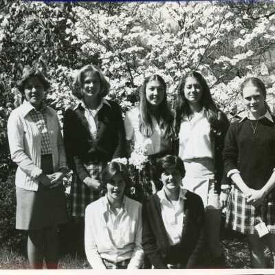 Students pose outside on campus, 1970s