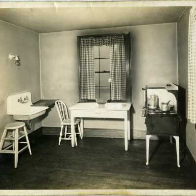 Club village, interior view. kitchen: sink, table, stove.