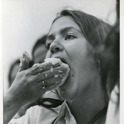 Close up shot of a student eating cake in the 1970's.