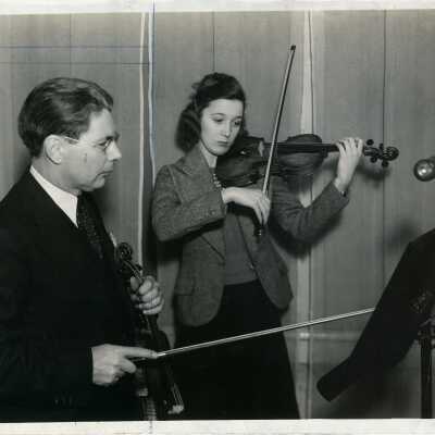 Dr. Alan Irwin and young lady with violins