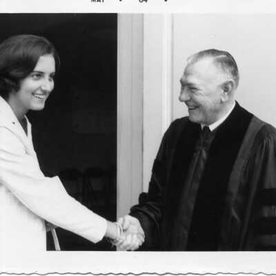 Student shaking hand of a clergyman in May of 1964.
