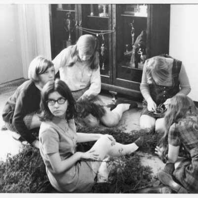 Group of Harpeth Hall students seated, working on some greens. 1973