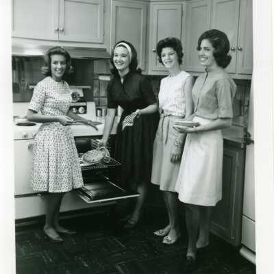 Seniors pose in a kitchen, 1963
