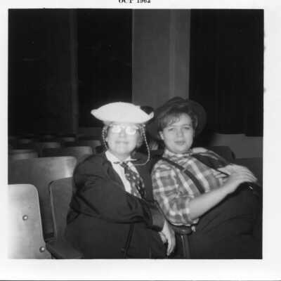 Students in costume sitting in the auditorium chairs in 1962.