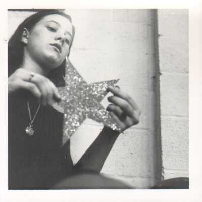 Student holding star made of glitter, 1960s