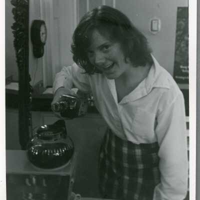 Student poses with drink, 1970s