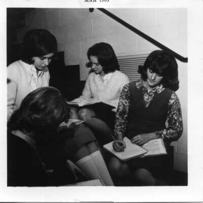 Students studying on stairs in 1965