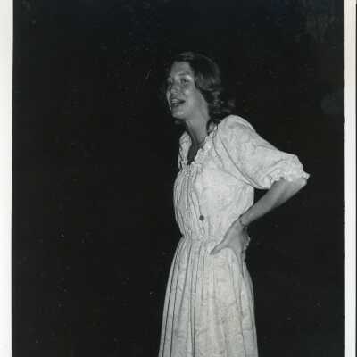Candid shot of a student wearing a white dress in the 1970's.