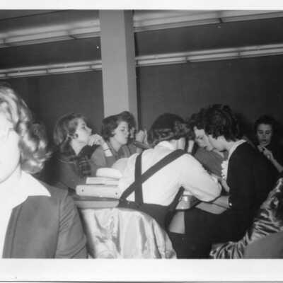 Students in 1961 sitting around a table with their books.