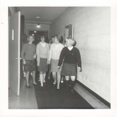 Group of students walking down a hallway in 1968