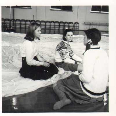 Students sitting in Bullard Gym on a white sheet in 1968