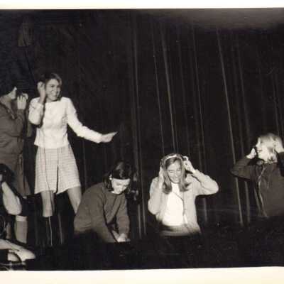 Students on stage with headphones, 1960s