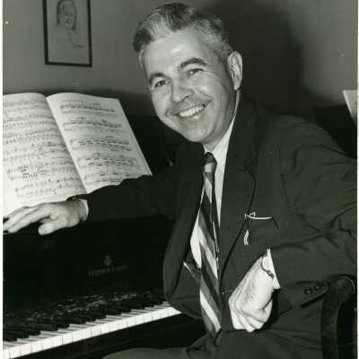 Photo of Dr. Alan Irwin, sitting at a piano. Musician. Dean of the Ward-Belmont School Conservatory of Music.