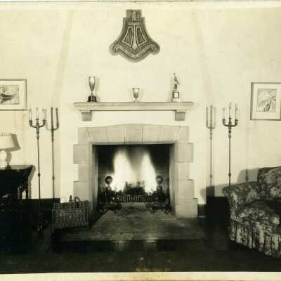 Club Village, interior view, fireplace. Coat of arms over fireplace reads, "TCC" so this was probably the club house for the Twentieth Century Club.