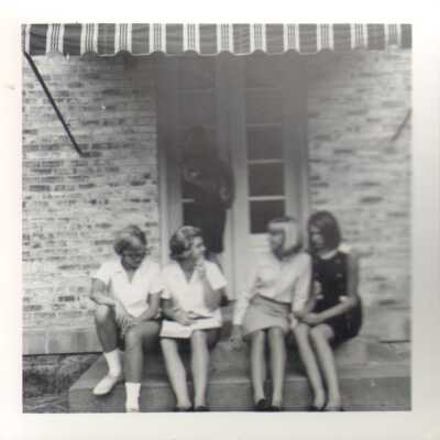 Students sitting on steps of the Junior Room, 1968